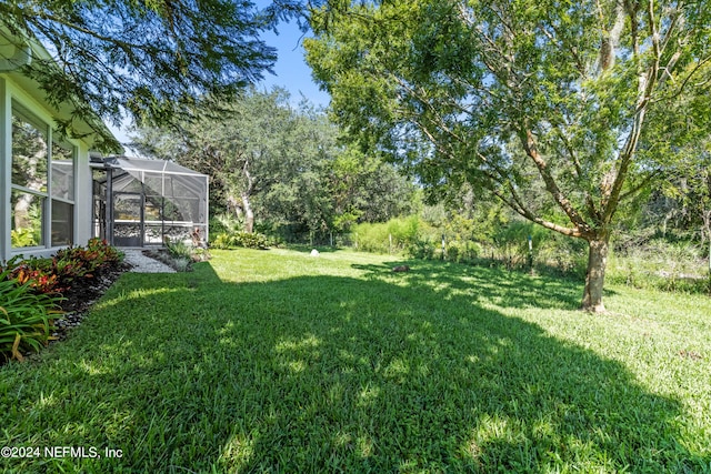 view of yard with glass enclosure