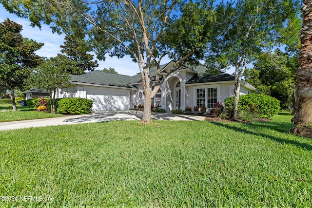 view of front of home with a front lawn and a garage