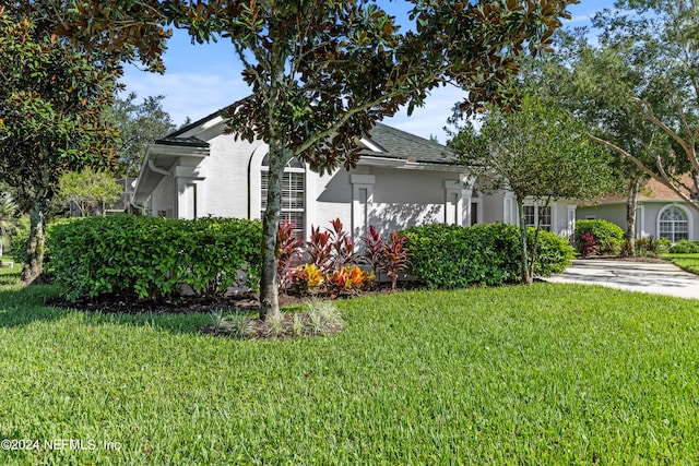 view of side of property with a yard