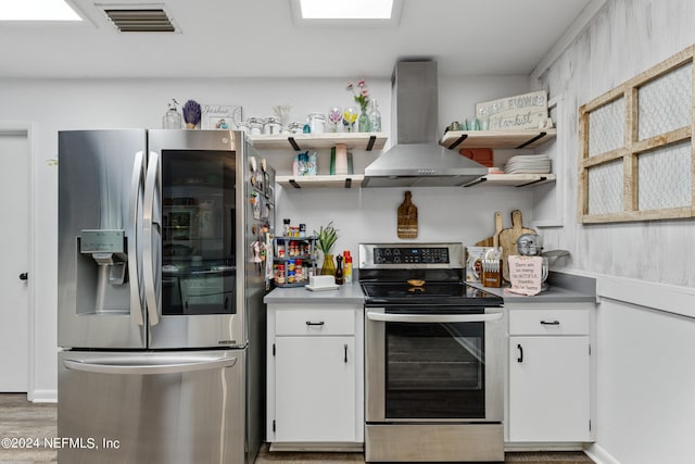 kitchen with white cabinetry, light hardwood / wood-style floors, appliances with stainless steel finishes, and island range hood