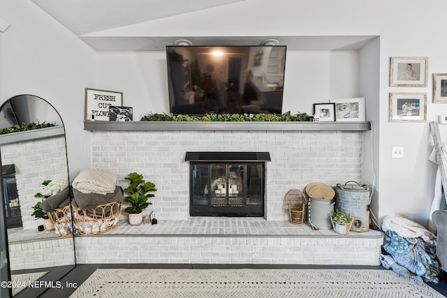 living room with a fireplace and vaulted ceiling