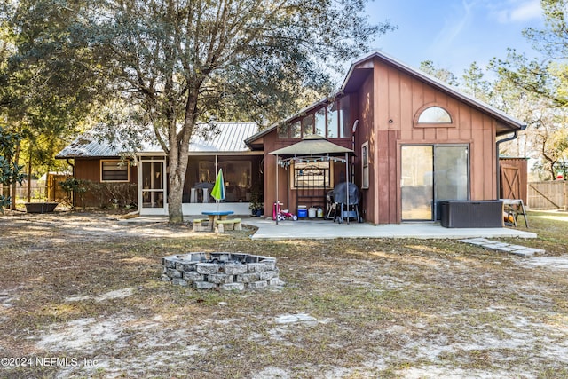 back of property featuring an outdoor fire pit, central air condition unit, and a patio