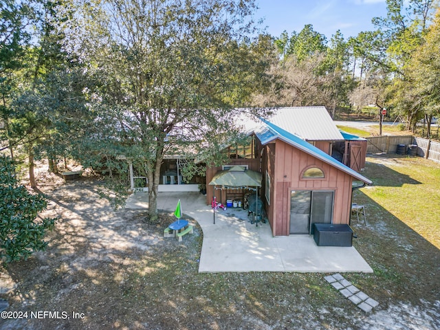 rear view of house featuring a patio area and a lawn