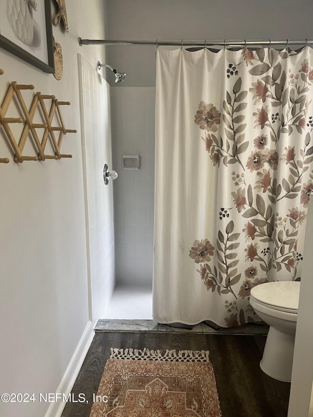 bathroom featuring wood-type flooring and toilet