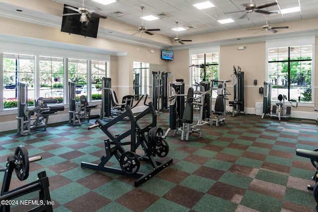 exercise room featuring dark carpet and a wealth of natural light