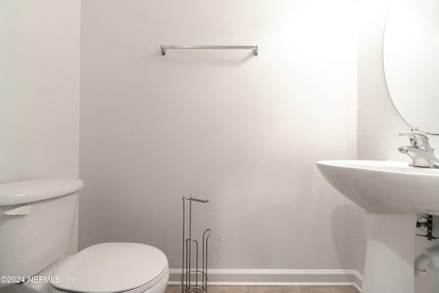 bathroom featuring sink, tile patterned flooring, and toilet