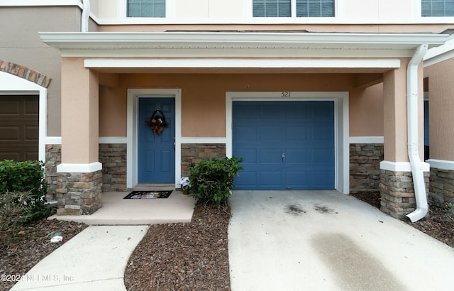 view of exterior entry with a garage