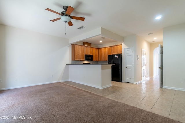 kitchen with kitchen peninsula, light colored carpet, ceiling fan, and black appliances