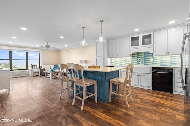 kitchen featuring a kitchen breakfast bar, white cabinets, dishwasher, and dark hardwood / wood-style flooring