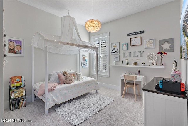 carpeted bedroom featuring a textured ceiling