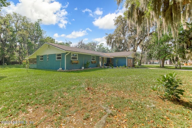 rear view of property with a yard