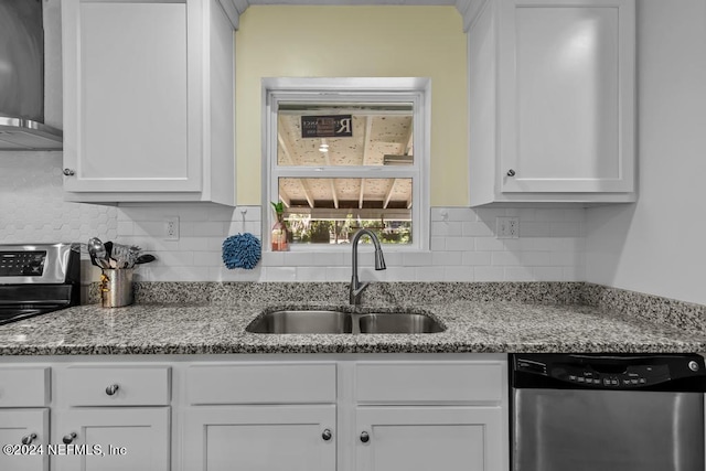 kitchen featuring light stone countertops, white cabinetry, sink, stainless steel dishwasher, and wall chimney exhaust hood