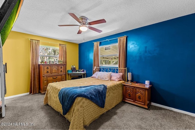 bedroom featuring dark carpet, ceiling fan, and a textured ceiling