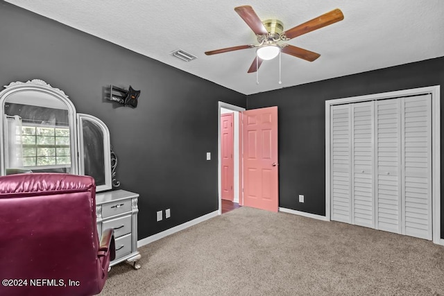 carpeted office space featuring ceiling fan