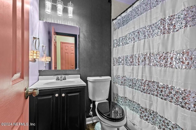 bathroom featuring oversized vanity and toilet