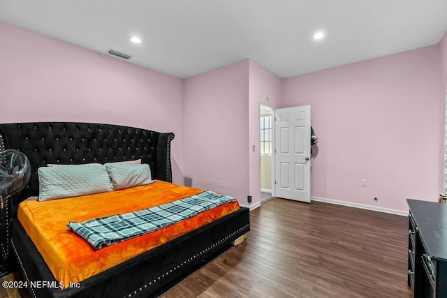 bedroom with dark hardwood / wood-style flooring