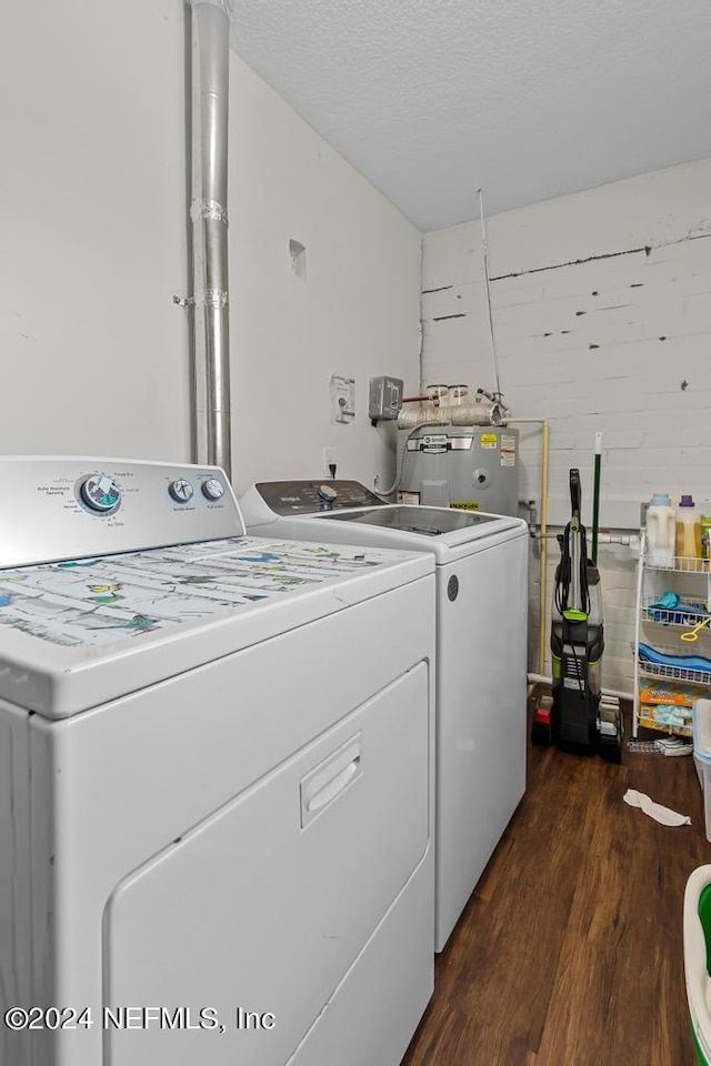 clothes washing area with electric water heater, separate washer and dryer, and dark hardwood / wood-style floors