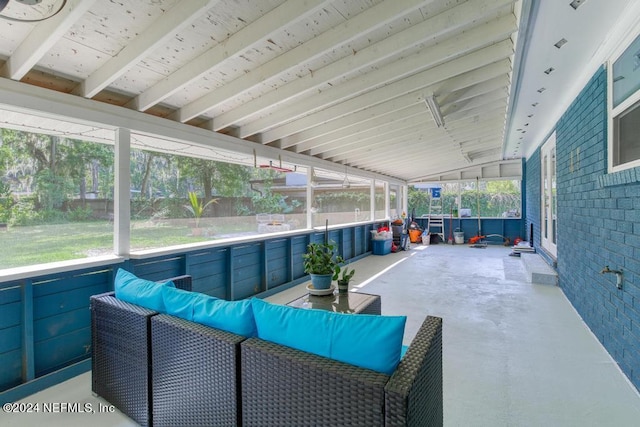 sunroom / solarium featuring vaulted ceiling