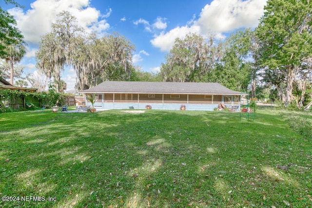back of property featuring a lawn
