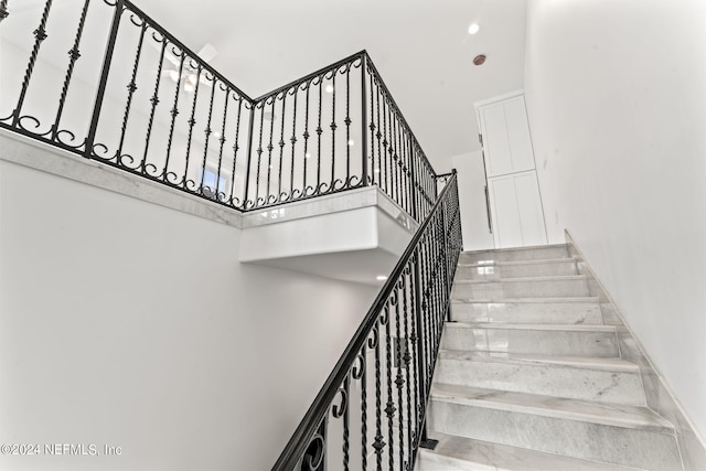 staircase featuring a high ceiling