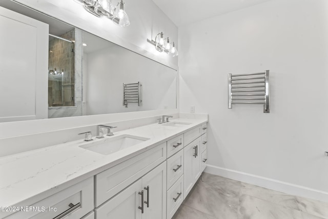 bathroom with a shower with door, radiator heating unit, and vanity