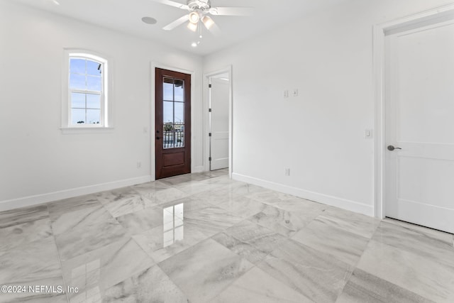 foyer entrance with ceiling fan