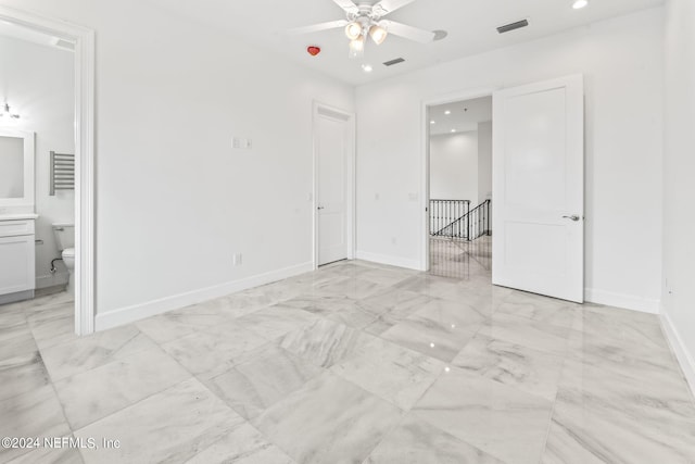 unfurnished bedroom with ceiling fan and ensuite bathroom