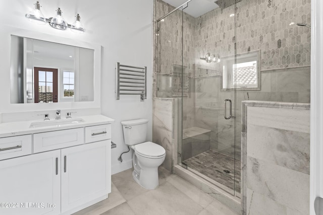 bathroom with tile patterned flooring, a shower with shower door, toilet, and vanity