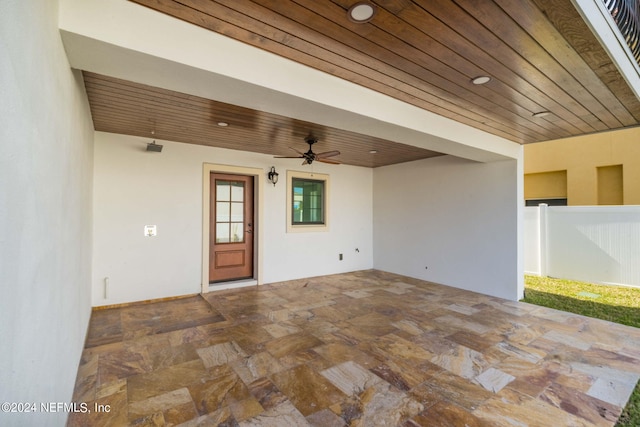 unfurnished room with wood ceiling and ceiling fan