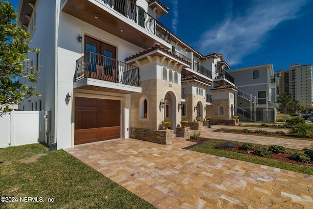 view of front of house with a balcony and a garage