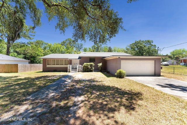 single story home with a front yard and a garage