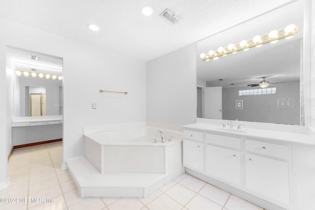 bathroom featuring ceiling fan, tile patterned flooring, a bath, a textured ceiling, and vanity