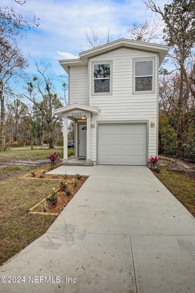 front of property featuring a front lawn and a garage