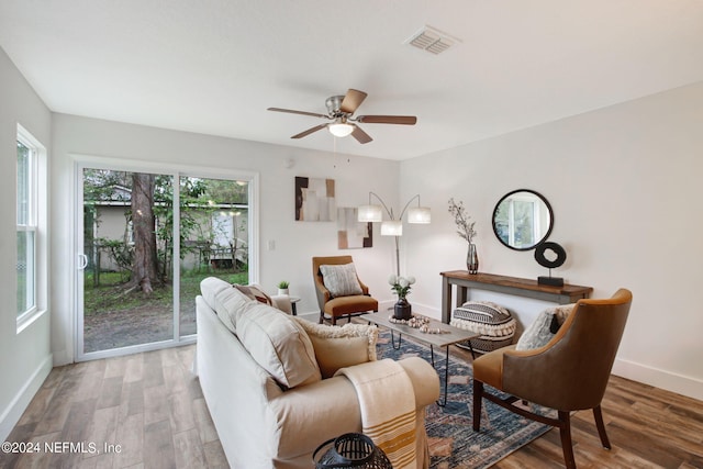 living room with ceiling fan and light wood-type flooring