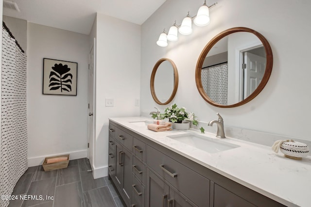 bathroom with double vanity and tile floors