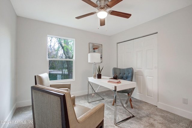 home office featuring light carpet and ceiling fan