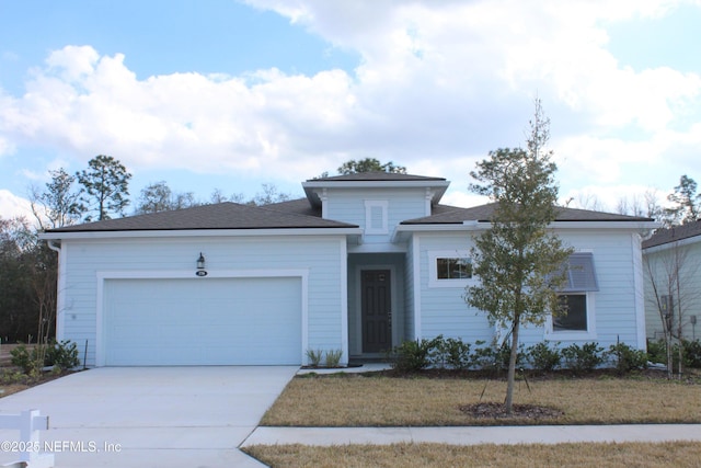 view of front of property featuring a garage and a front yard