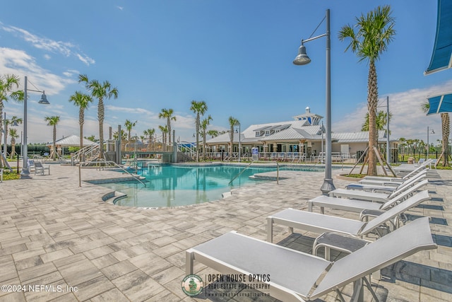 community pool featuring a patio and fence