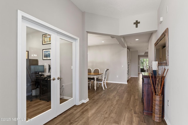 corridor with recessed lighting, french doors, baseboards, and wood finished floors