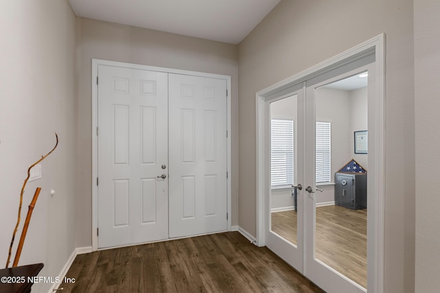 entryway featuring dark wood finished floors, french doors, and baseboards