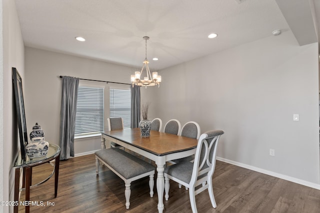 dining area with a notable chandelier, recessed lighting, dark wood-type flooring, and baseboards