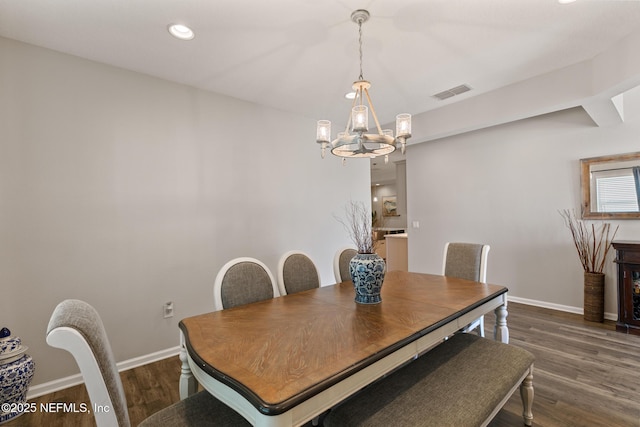 dining area with visible vents, dark wood finished floors, recessed lighting, an inviting chandelier, and baseboards