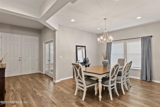 dining space with recessed lighting, wood finished floors, baseboards, and a chandelier