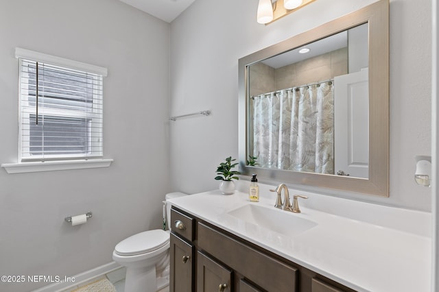 full bathroom with vanity, toilet, a shower with curtain, and baseboards