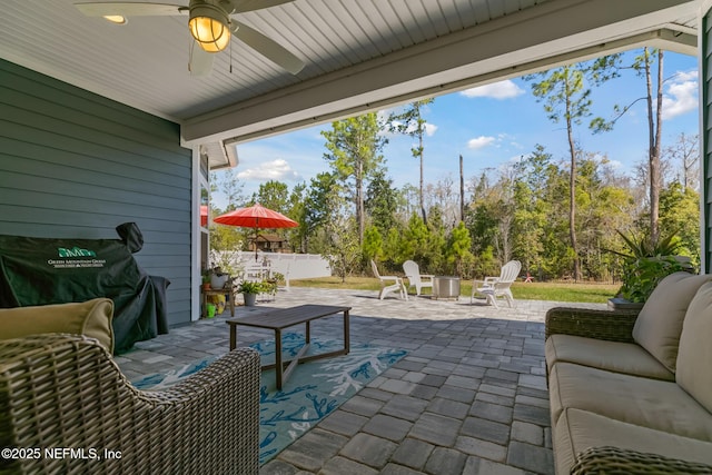 view of patio / terrace with ceiling fan and fence