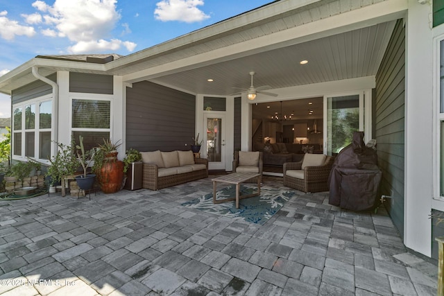 view of patio with an outdoor living space and ceiling fan