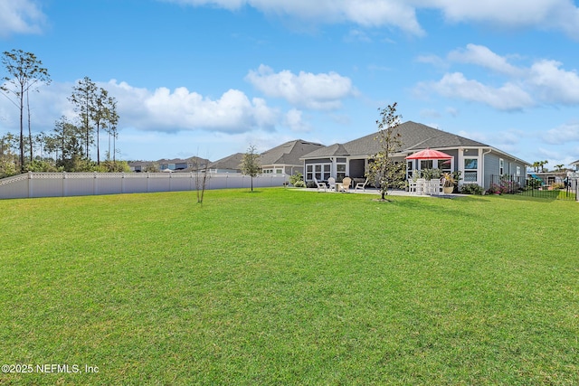 view of yard with a patio area and a fenced backyard