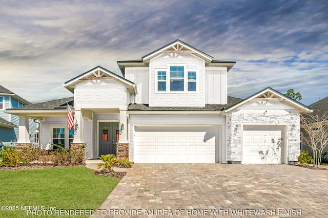 view of front of house with decorative driveway and stone siding