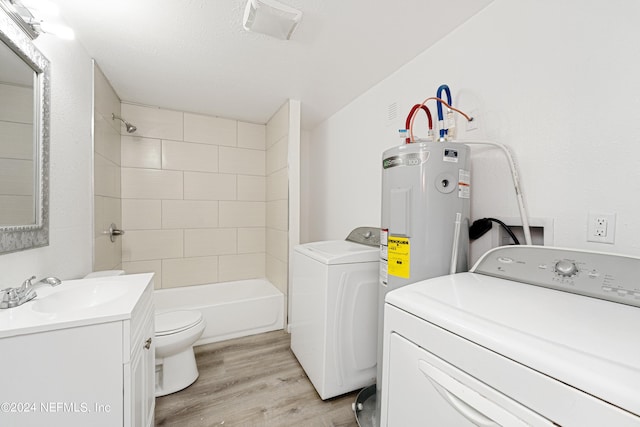 washroom featuring washing machine and dryer, light hardwood / wood-style floors, and sink