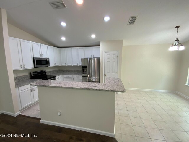 kitchen featuring light tile patterned flooring, stainless steel appliances, light stone counters, and decorative light fixtures